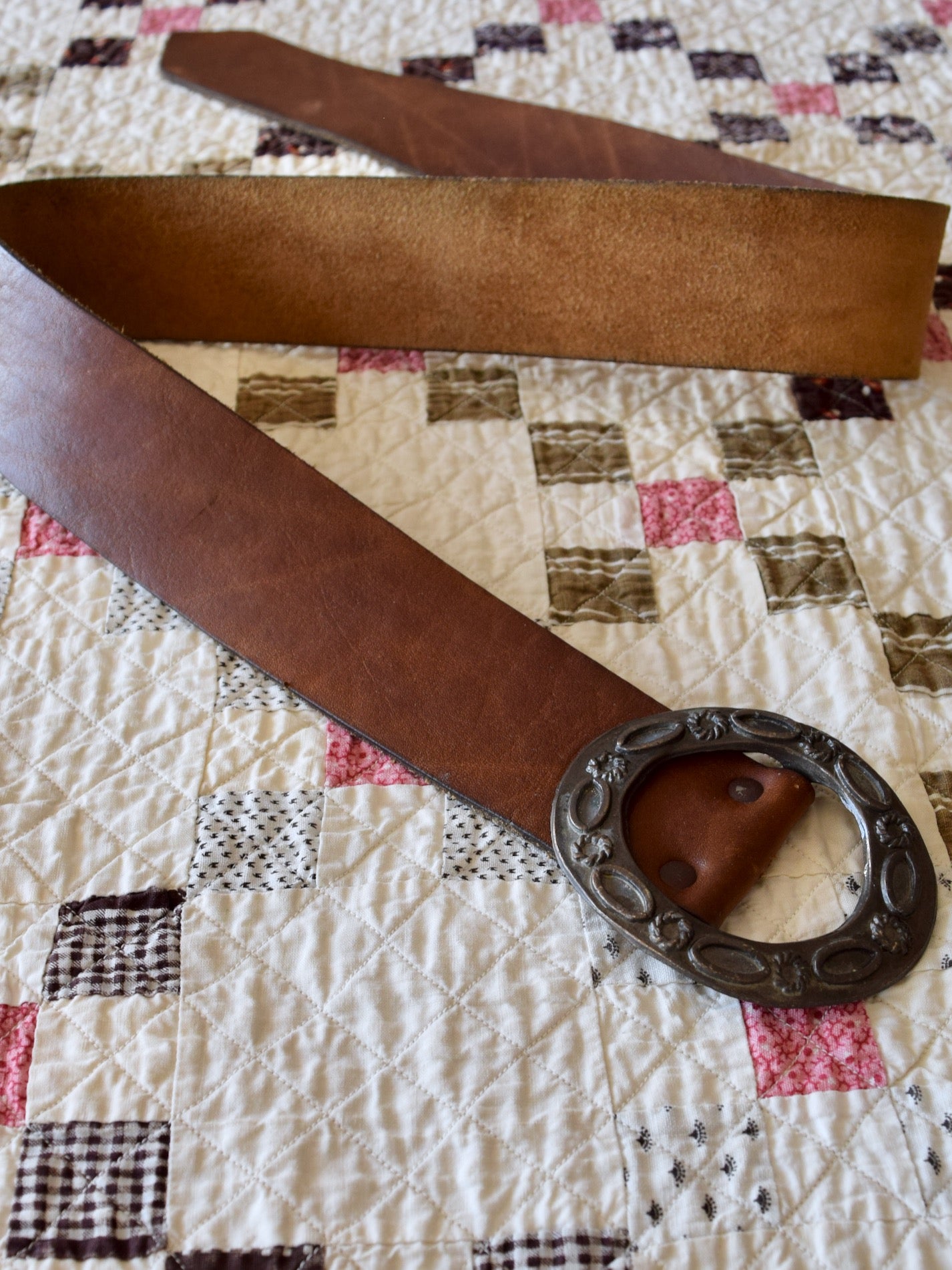 vintage 1970s medium brown leather belt with cast metal buckle